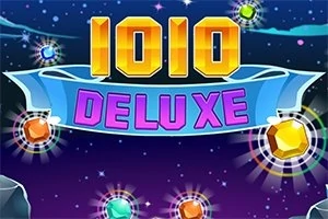 Napis 1010 DELUXE na tle nocnego nieba z kolorowymi, świecącymi klejnotami