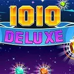 Napis 1010 DELUXE na tle nocnego nieba z kolorowymi, świecącymi klejnotami