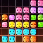 Kolorowe, uśmiechnięte klocki ułożone w rzędy na czarnym tle siatki