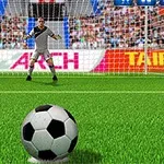 Piłka nożna leży na murawie przed bramką, w której stoi bramkarz gotowy do obrony, a w tle widać trybuny z kibicami