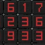 Czerwone cyfry wyświetlane na siatce czarnych, kwadratowych paneli