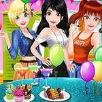 Trzy dziewczyny ubrane w kolorowe stroje na przyjęciu z balonami i deserami na stole