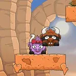 Dwa rysunkowe bizony o różnych kolorach stojące na skalnej platformie w kanionie