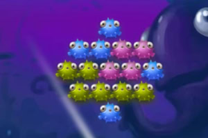 Kolorowe, okrągłe stworki z oczami ułożone w trójkątry na fioletowym tle