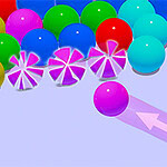 Kolorowe kule na jasnofioletowym tle z wystrzeliwaną różową kulą i wskazującą strzałką