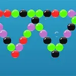 Kolorowe kulki ułożone w dwóch odwróconych trójkątach na niebieskim tle