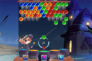 Czarodziejka w kapeluszu strzela kolorowymi kulkami do tablicy z kolorowymi bąbelkami na tle zamku