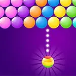 Kolorowe kulki ułożone w rzędach na fioletowym tle, z jedną kulką na dole gotową do strzału