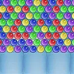 Kolorowe, błyszczące kulki ułożone w ciasnych rzędach na niebieskim tle