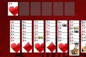 Karty do pasjansa ułożone na czerwonym tle w różnych kolumnach z widocznymi symbolami serca i karo