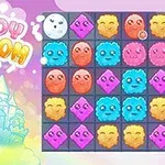 Pastelowy zamek w chmurach z napisem Cloudy Kingdom obok planszy z kolorowymi, uśmiechniętymi postaciami w różnych kształtach i kolorach