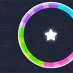 Kolorowy pierścień podzielony na segmenty w odcieniach zieleni, fioletu, różu i niebieskiego z białą gwiazdą w środku na ciemnym tle