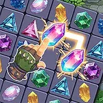 Różnokolorowe klejnoty na planszy z ręką wskazującą na dwa połączone różowe kryształy, w tle kamienie i mech