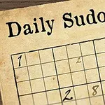 Krzyżówka Sudoku w stylu retro z piórem na drewnianym biurku