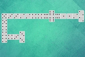 Ułożone pionki domina na zielonym tle w formie litery L