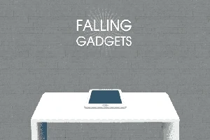 Tablet leżący na białym stole na tle szarej ściany z napisem Falling Gadgets