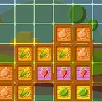 Kolorowe klocki z ikonami warzyw na tle wiejskim z widoczną stodołą i ogrodzeniem