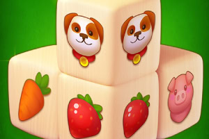 Klocki z ilustracjami: pieska, marchewki, truskawki i świnki na zielonym tle