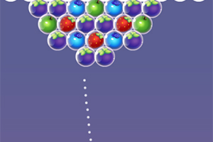 Kolorowe bąbelki owoców w różnych kolorach ułożone w trójkątny wzór na fioletowym tle z przerywaną linią wskazującą kierunek
