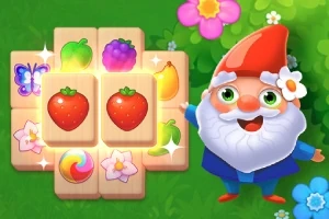 Krasnoludek w czerwonym kapeluszu stoi obok planszy z kolorowymi obrazkami owoców i kwiatów