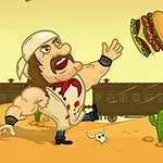 Mężczyzna w białej bandanie i muskułach kopie hamburgera na pustynnym tle z kaktusami, psem i pociągiem, obok stoi starszy mężczyzna z laską ozdobioną czaszkami