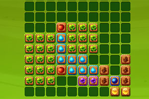 Kolorowe kafelki o różnych wzorach ułożone na zielonej siatce kwadratowej