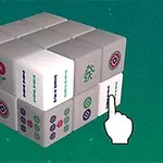 Sześcian złożony z mniejszych bloczków z symbolami przypominającymi elementy mahjonga oraz ręka wskazująca na jedną ze ścianek