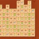 Prostokątna plansza z układem klocków, na których znajdują się wzory z kółkami, kreskami i chińskimi znakami na brązowym tle