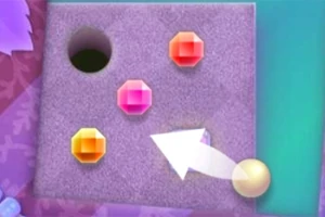 Kolorowe klejnoty na teksturowanej powierzchni z otworem i białą strzałką wskazującą na złotą kulę