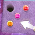 Kolorowe klejnoty na teksturowanej powierzchni z otworem i białą strzałką wskazującą na złotą kulę