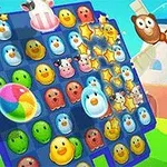 Kolorowa plansza z uśmiechniętymi zwierzętami i kulą plażową, na tle wiejskiego krajobrazu z wiatrakiem i chmurami