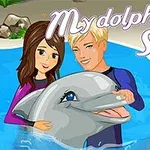 Para postaci pływających z delfinem w basenie z tytułem My Dolphin Show 2 na górze