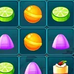 Kolorowe słodycze i desery ułożone w siatkę z limonkami, pomarańczowymi cukierkami, fioletowymi żelkami, tortami z owocami i czekoladowym ciastkiem