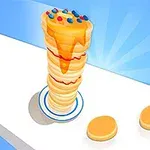 Wieża naleśników polanych syropem, udekorowana kolorowymi cukierkami, na białym tle