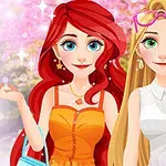 Dwie uśmiechnięte animowane postacie kobiece, jedna z długimi rudymi włosami w pomarańczowej sukience, druga z blond włosami i okularami przeciwsłonecznymi na głowie, stoją na tle kwitnących drzew