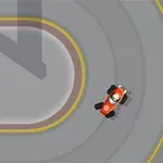 Mały czerwony samochód wyścigowy na torze z ostrym zakrętem, z widocznymi żółtymi oznaczeniami