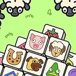 Stosy kolorowych klocków z rysunkami zwierząt i przedmiotów otoczone owcami na zielonym tle