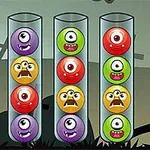 Kolorowe, jednookie potwory w cylindrycznych pojemnikach na tle krajobrazu