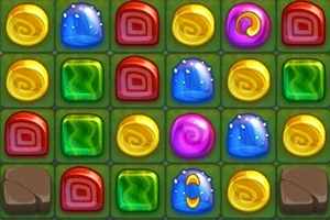 Kolorowe, błyszczące cukierki w siatce złożonej z prostokątów o różnych kształtach i kolorach, na zielonym tle