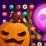 Dynia o groźnym wyrazie twarzy oraz różowy lizak z czaszką w otoczeniu cukierków na fioletowym tle