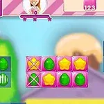 Kolorowe elementy w kształcie gwiazdek, kropli i serc na tle cukierkowej grafiki z licznikiem ruchów i wynikiem punktowym