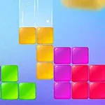Kolorowe, przezroczyste klocki w różnych kształtach zestawione na niebieskim tle