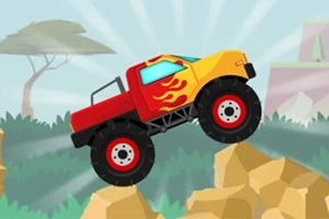 Czerwono-żółta ciężarówka terenowa z płomieniami na boku jedzie po kamienistym terenie z drzewem w tle