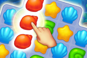 Ręka wskazująca na czerwone muszle w układance z elementami w kształcie muszli, gwiazdek i zielonych zakrętasów na niebieskiej siatce