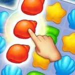 Ręka wskazująca na czerwone muszle w układance z elementami w kształcie muszli, gwiazdek i zielonych zakrętasów na niebieskiej siatce