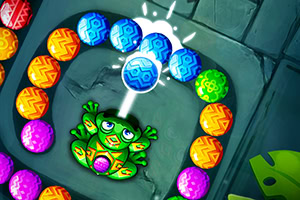 Żaba strzelająca kolorowymi kulkami w inne kulki w wężowym układzie na tle kamiennej ścieżki